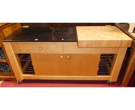 A contemporary beech long kitchen work table, having a polished quartz surface, further removable butcher's block, single fri