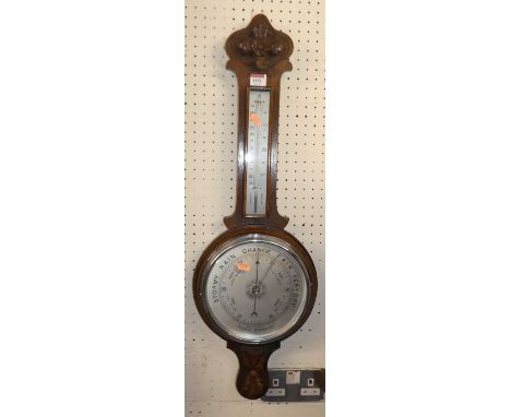 An early 20th century oak wheel barometer