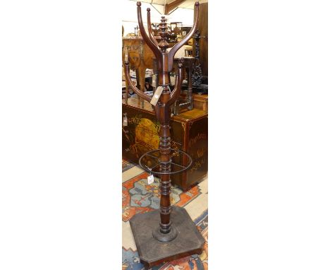 A Victorian mahogany hall-tree, the six raised branch arms on ring turned column, with painted iron cylindrical four division