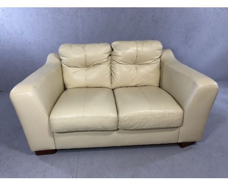 Contemporary cream leather two-seater sofa, approx 150cm in length (A/F)