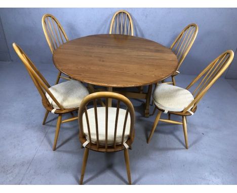 Ercol drop leaf table and six stick back chairs, table approx 128cm wide x 140cm in length (fully extended)