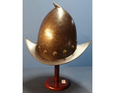 Italian Morion-Cabasset helmet, late 16th C, skull and brim constructed in two halves with pear drop finial, brim having roll