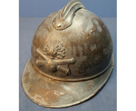 WWI French artillery steel helmet with traces of painted detail complete with leather liner. 
