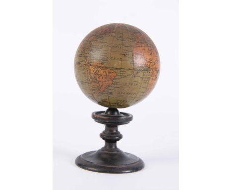 AN EARLY 19TH CENTURY MINIATURE TERRESTRIAL DESK GLOBE 3 inches in diameter on a turned ebonised base - 12.5cm tall 7.5cm wid