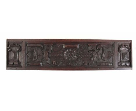 A LATE 16TH CENTURY CARVED OAK PANEL centred with flowerhead 85.5cm wide 20.5cm high