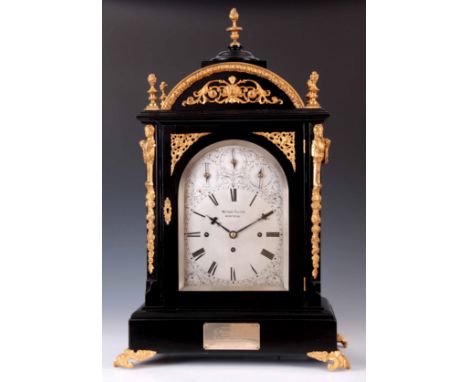 WATSON &amp; PELTON, MONTREAL. A LARGE EBONISED AND ORMOLU MOUNTED QUARTER CHIMING BRACKET CLOCK the arched case surmounted b