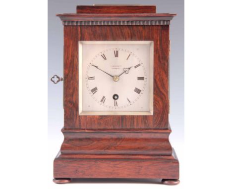 J. BENNETT, NORWICH. A SMALL MID 19TH CENTURY ROSEWOOD FOUR GLASS MANTEL CLOCK the case of square form on an ogee-moulded pli