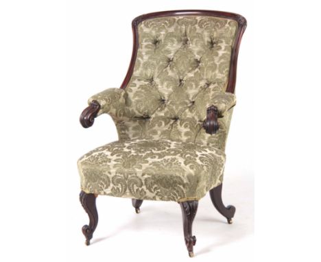 A MID 19TH CENTURY ROSEWOOD ARM CHAIR having a leaf carved frame, upholstered button back and floating scroll arm supports; s