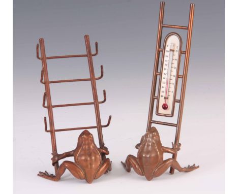 A PAIR OF LATE 19TH CENTURY NOVELTY BRONZE FROG DESK STANDS formed as a seated frog with copper patina holding a ladder pen r