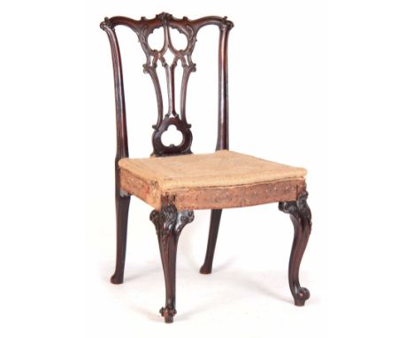 A FINE GEORGE III CHIPPENDALE STYLE SIDE CHAIR with rococo leaf carved open pierced splat, upholstered seat; standing on carv