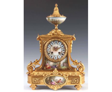 A LATE 19TH CENTURY FRENCH ORMOLU AND PORCELAIN PANELLED MANTEL CLOCK the case with urn finial above a gilt brass case with a