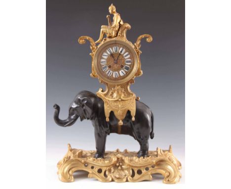 AN LATE 19TH CENTURY FRENCH ORMOLU AND PATINATED BRONZE ELEPHANT MANTEL CLOCK the elephant standing on a gilt rococo style ba