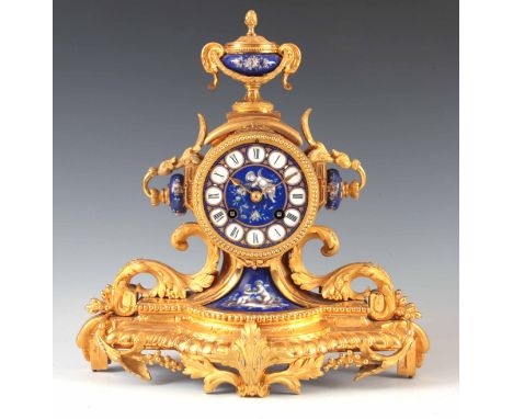 A LATE 19TH CENTURY FRENCH ORMOLU AND PORCELAIN PANELED MANTEL CLOCK having an urn finial above an ornate case with acanthus 