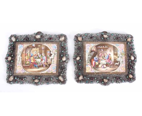 A PAIR OF LIMOGES ENAMEL PLAQUES decorated with tavern scenes mounted in filigree frames set with garnets, turquoise and natu