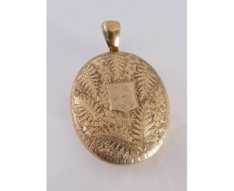 Oval Victorian locket, with engraved fern decoration and initial R, unmarked but tests as 9ct gold. Weight 15 grams