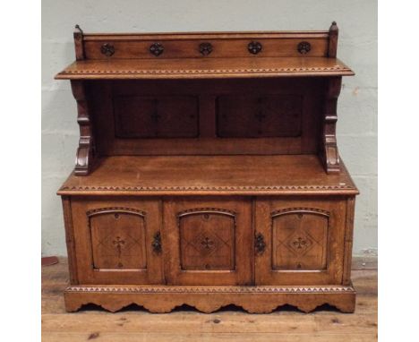 Arts and Crafts carved oak sideboard cabinet in the style of Pugin,  with shelf back and cupboards under,  4'4" wide