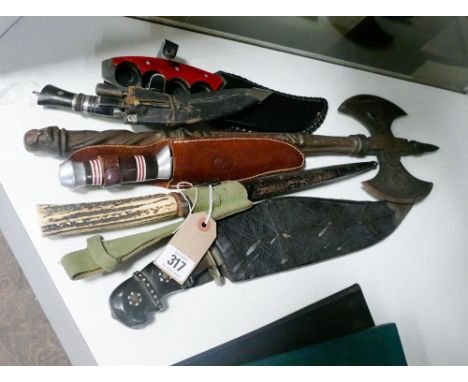 Various knives and daggers and an axe 