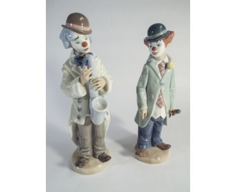 2 Lladro figurines of clowns, one playing the saxophone - measuring approximately 23cm tall  No obvious  signs damage or repa
