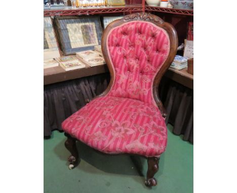 A balloon-back chair with acanthus leaf carving, button upholstered backrest, on ceramic castors a/f   