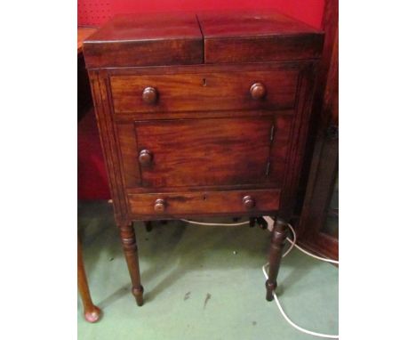 A George III mahogany gentleman's washstand the rising top and internal tilting rising mirror with push button release over a