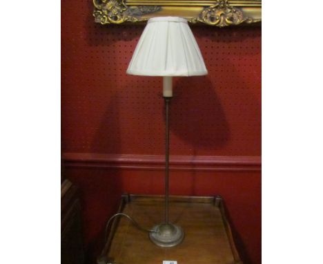 A slender table lamp with silk shade