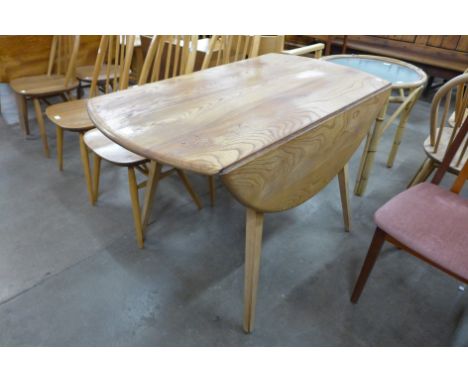 An Ercol Blonde elm and beech drop leaf table 