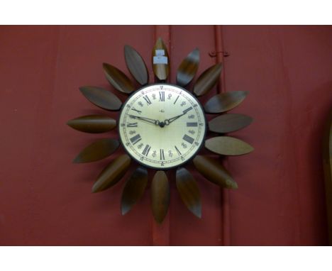 A teak sunburst wall clock 
