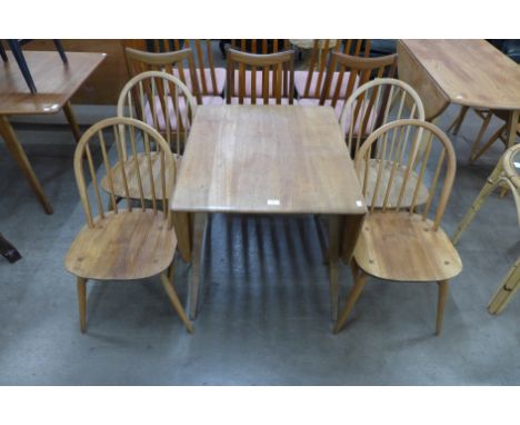 An Ercol Blonde elm and beech drop leaf table and four Windsor chairs 