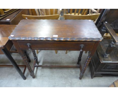 A carved oak bobbin turned single drawer side table 