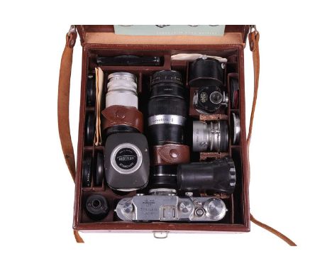 A Lecia IIIc camera body, circa 1950, in a fitted brown leather Leitz carry bag, the camera numbered 489716, together with tw