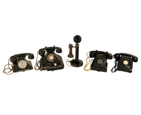 A 300 series black Bakelite telephone  - together with another with an exchange mechanism, an extension telephone, a candlest