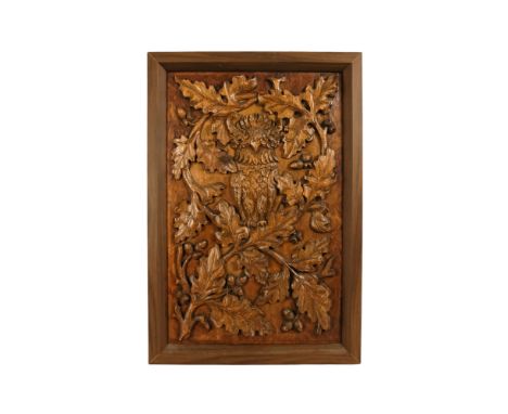 A 20th century carved oak panel - showing a owl in an oak tree, 66 x 45cm.