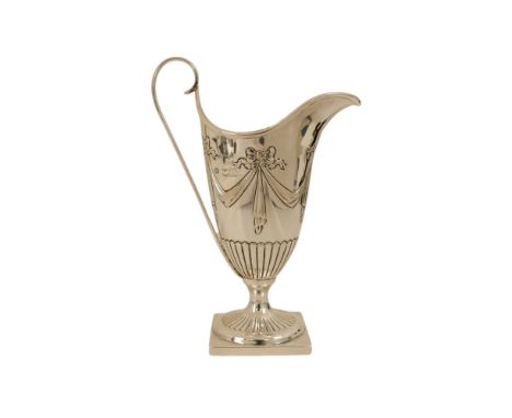 A silver helmet shaped cream jug - London 1900, in a neo classical style, repousse decorated with ribbon swags and with a squ