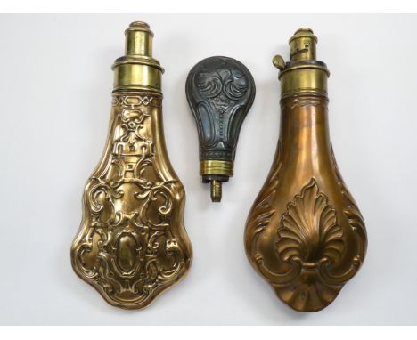 A 19th century brass repousse powder flask - with strapwork decoration, 20cm long, together with two further powder flasks. (