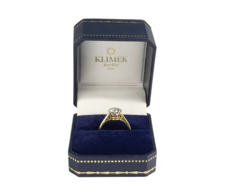 An 18ct gold single stone diamond ring - claw set with pierced shoulders, with an insurance certificate indicating stone weig