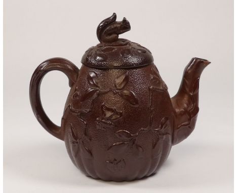 A late 18th century redware teapot - gourd shaped and decorated with foliage, the knop in the form of a squirrel, 12cm high.