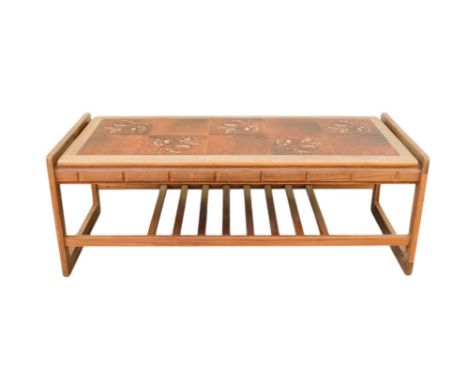A vintage teak and tile top table - with a rectangular top, the end supports joined by a slatted undertier, 116 x 50 x 44cm.