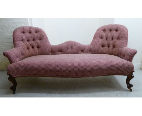 A late Victorian double spoonback settee, part button upholstered in patterned maroon and cream coloured fabric, the overstuf