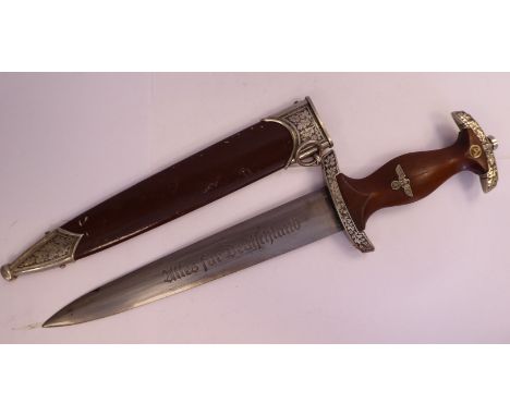 A German SA dagger, the moulded light-stained wooden handgrip with a spreadeagle and swastika emblem and cast oak leaf and ac