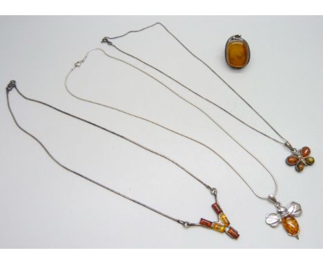 A collection of silver amber set jewellery including a ring, Q/R, a necklace, and two pendants on chains, 26g