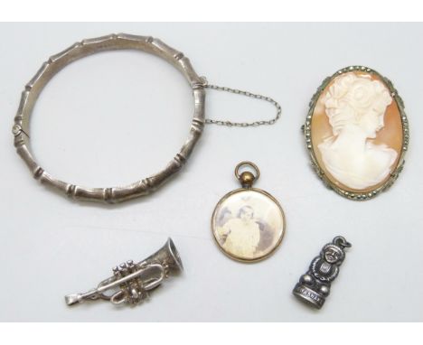 A collection of silver jewellery including a silver bangle, .800 cameo brooch/pendant, pendants, 25g total, and a gold plated