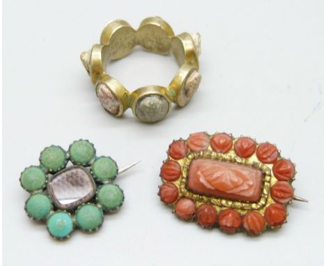 A Georgian gilt Vulcanite set ring, K/L, and two Georgian brooches including a carved coral example, 2.5cm, the other yellow 