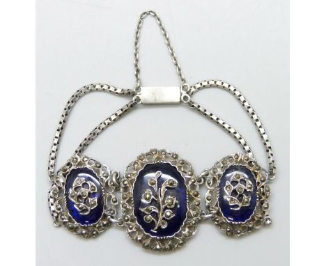 A white metal bracelet with blue panels and set with marcasite, possibly French, lacking some stones, 2.8cm central panel, 14