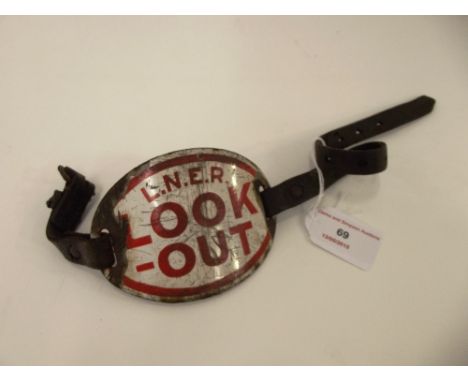 An LNER enamel "Look Out" arm band, from former North East region, original leather stramps