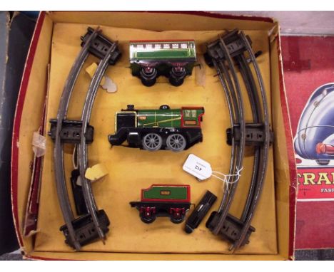 A French Hornby clockwork train set, comprising 0-4-0 engine and tender 3615; 2nd Class 4 wheel coach, mainly green and track