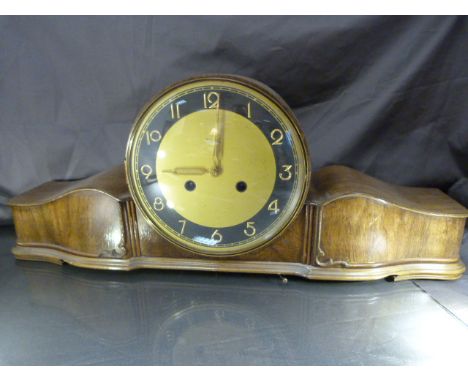 German Kienzle mantle clock of with Gilt Coloured face with a black band and gilt numbers in. The large rounded face is accen