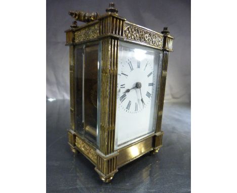 Brass cased Carriage Clock of Architectural style with pillared sides of face. Five bevel glass panels and enamel face having