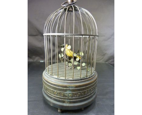 Victorian Singing Bird Automaton (Poss Bontems). The Brass case having a black and yellow bird perched on a stand with floral