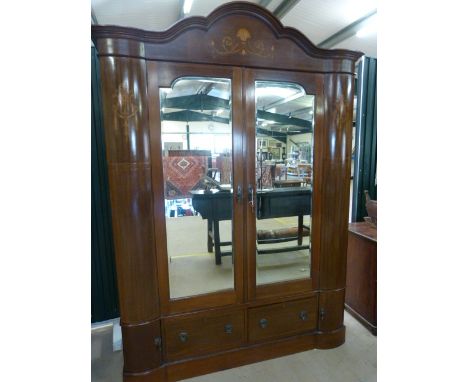 Two door Edwardian mahogany serpentine style wardrobe with inlay. Two mirrored doors reveal the hanging space. Outer edge is 