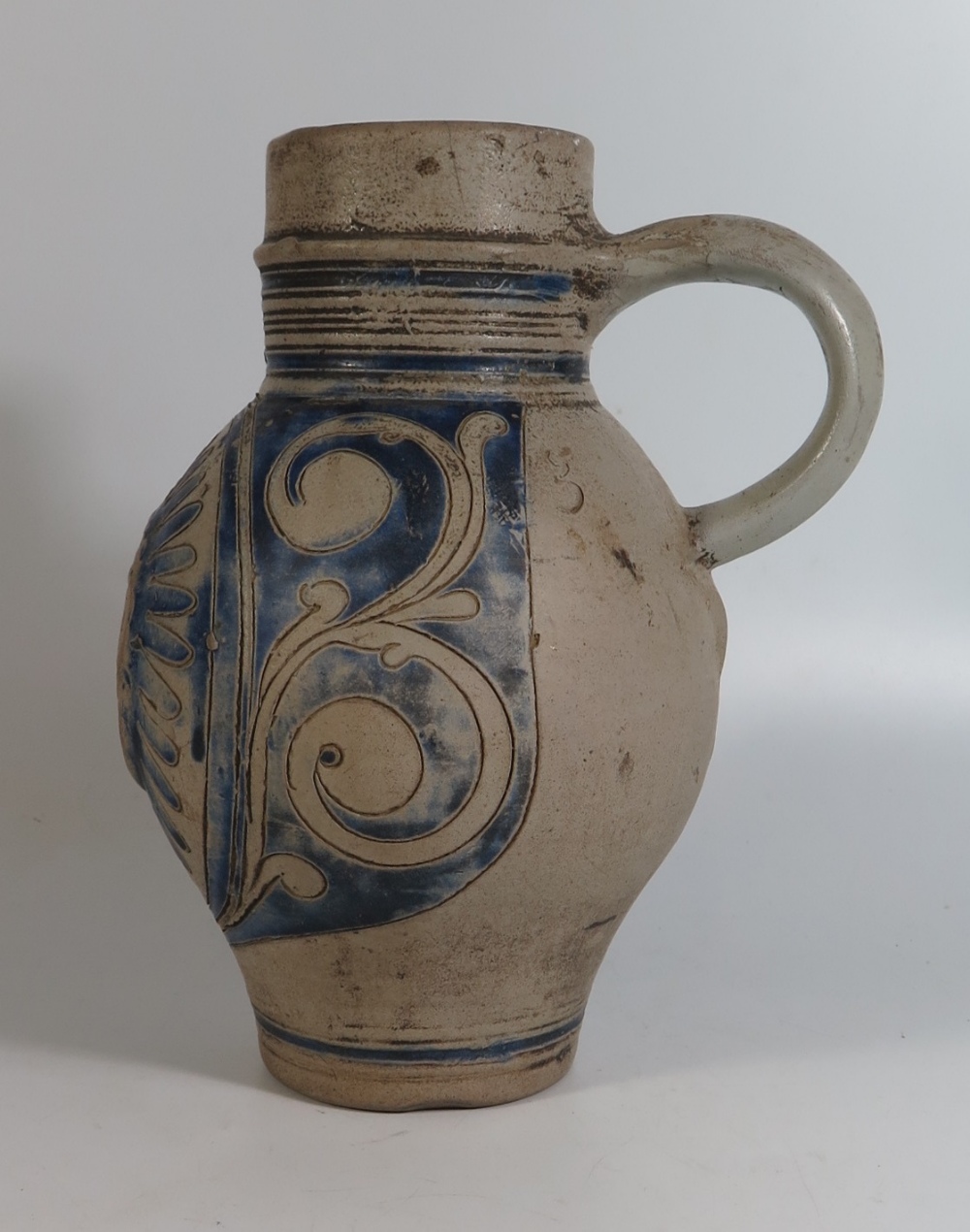 A Westerwald Pottery Jug with incised decoration and initials GR, 23cm